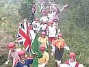 A long line of international contestants carry the flags of their countires